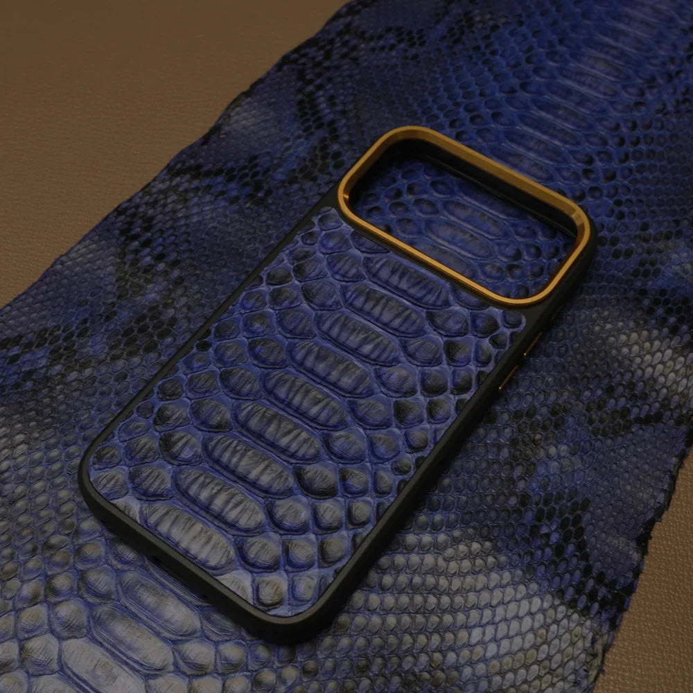 Blue python skin phone case with gold accent on a textured surface