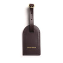 coffee brown leather luggage tag with a gold buckle on a white background