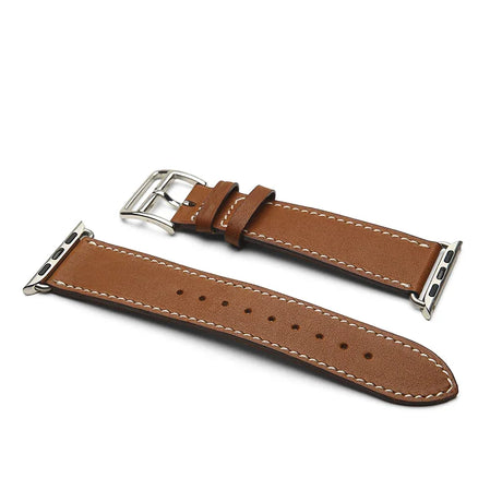 Brown leather watch strap with silver buckle on a white background
