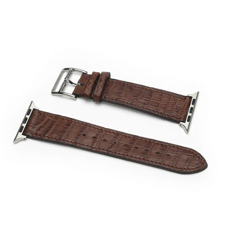 Brown exotic aligator skin watch strap with silver buckle on a white background
