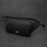 Black saffiano leather belt bag on a dark gray background