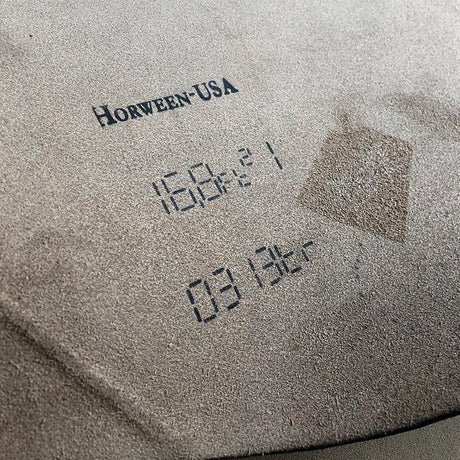 Close-up of a textured surface with 'Horween USA' branding and numbers.