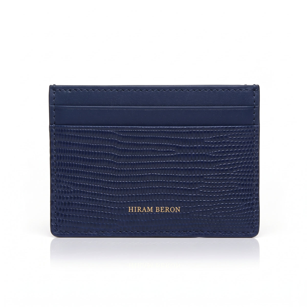 Navy blue lizard pattern leather cardholder on a white background