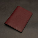 Red leather passport holder on a dark grey background