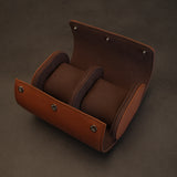 Inside view of an open, empty dual leather watch travel case with coffee brown microfiber interior and two pillows