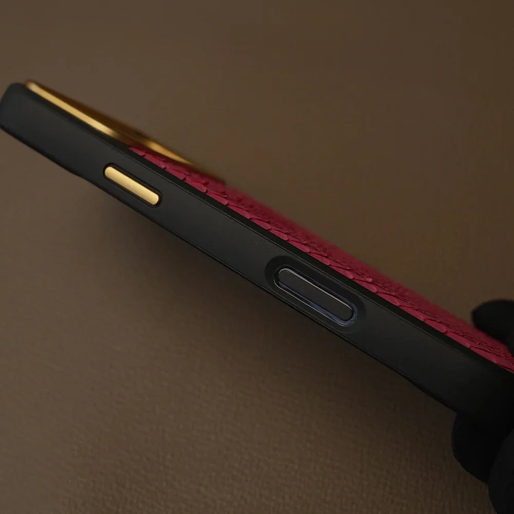 Luxury red textured leather phone case with gold accents and black bumper