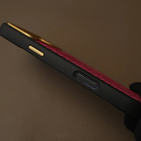 Luxury red textured leather phone case with gold accents and black bumper