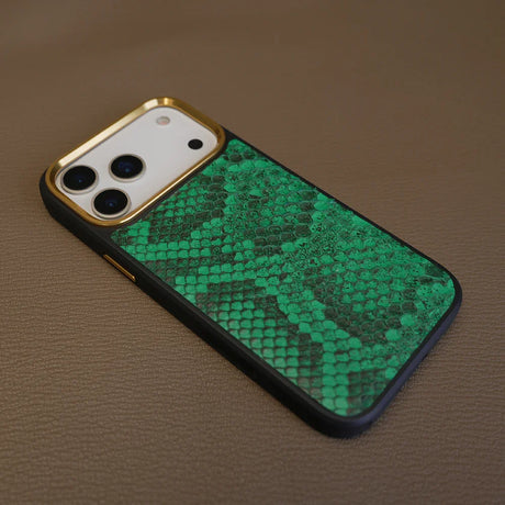 Phone case with green python skin pattern on a brown surface
