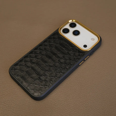 Detail shot of MagSafe black python skin phone case with gold trim