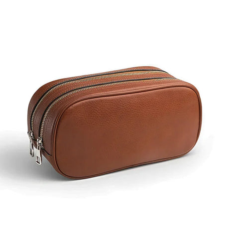 Brown leather toiletry bag with 2 zippers on a white background
