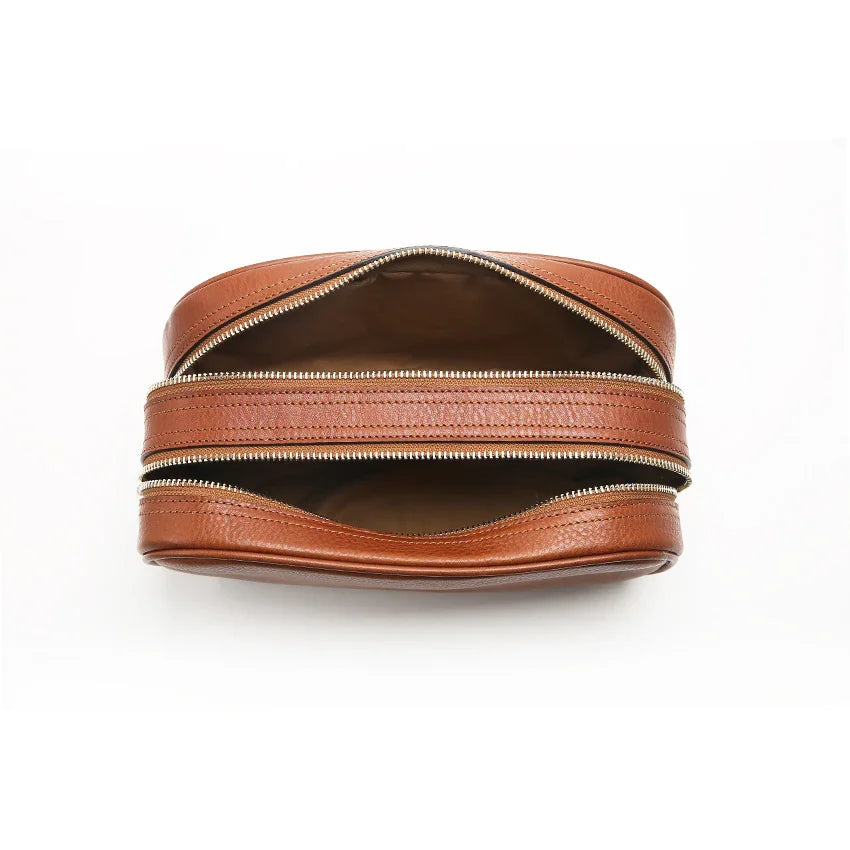 Brown leather zippered pouch on a white background