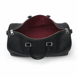 Black leather duffel bag with a red interior on a white background