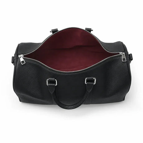 Black leather duffel bag with a red interior on a white background