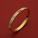 Gold bangle with colorful enamel pattern, luxury accessory for women, elegant wristwear design