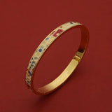 Gold bangle with colorful enamel pattern, luxury accessory for women, elegant wristwear design