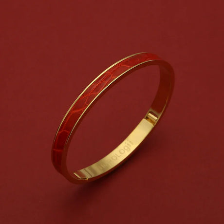 Luxury gold bangle with red crocodile texture, elegant women's jewelry on deep red background