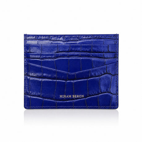 Blue crocodile-patterned cardholder with 'HIRAM BERON' branding on a white background