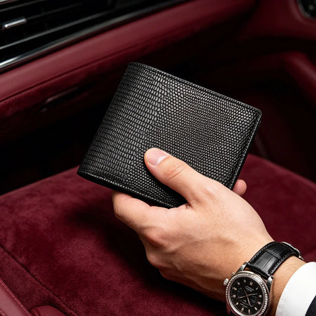Hand holding a black lizard pattern wallet with a watch on a red interior background