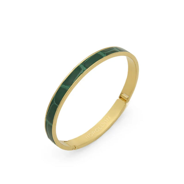 Gold bangle with green croc-embossed leather inlay, sleek luxury accessory