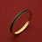 Gold bangle with black textured inlay, luxury leather-inspired design, elegant women's accessory